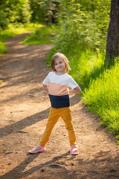 Caucasian girl of  years old jumping on a path in the forest