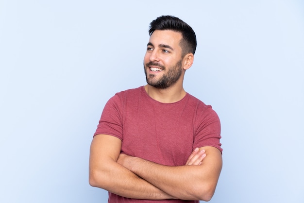 Caucasian handsome man over blue wall