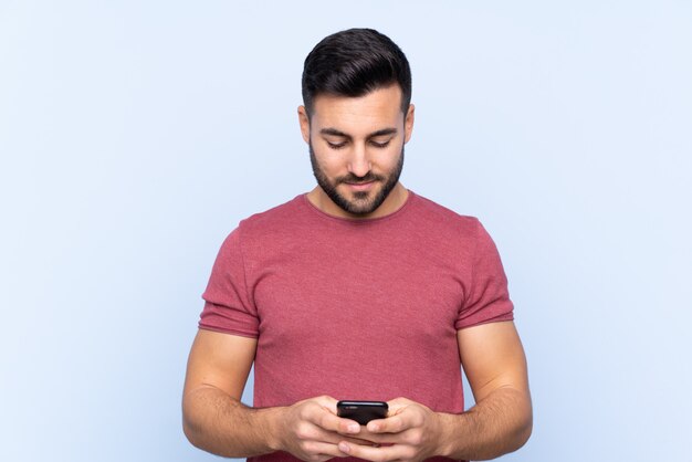 Caucasian handsome man over blue wall