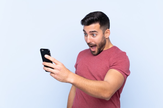 Caucasian handsome man over blue wall