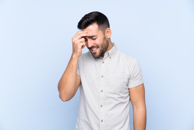 Caucasian handsome man over blue wall