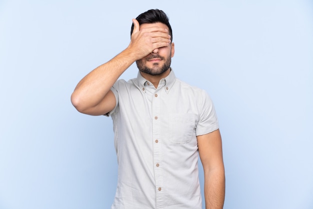 Caucasian handsome man over blue wall