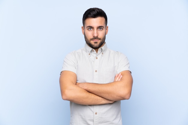 Caucasian handsome man over blue wall