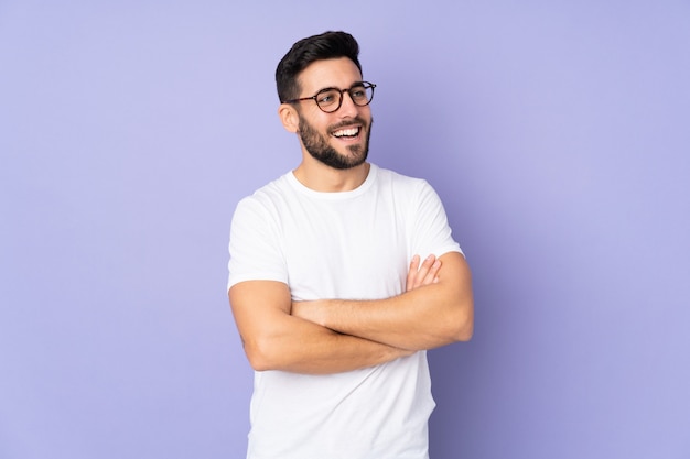 Caucasian handsome man over isolated wall happy and smiling