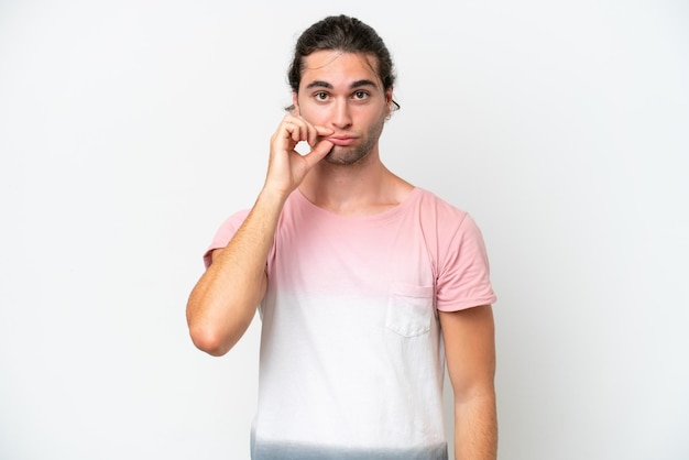 Caucasian handsome man isolated on white background showing a sign of silence gesture