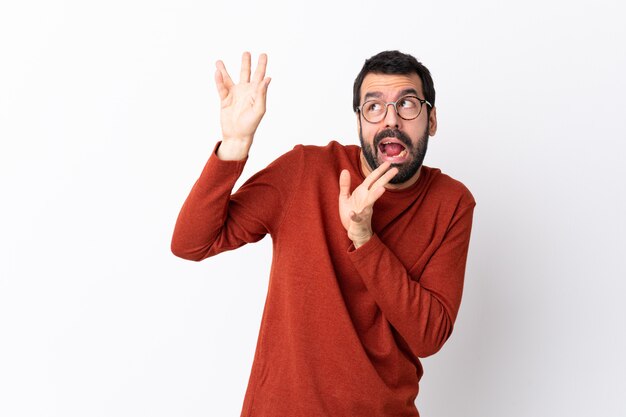 Caucasian handsome man with beard over white nervous and scared