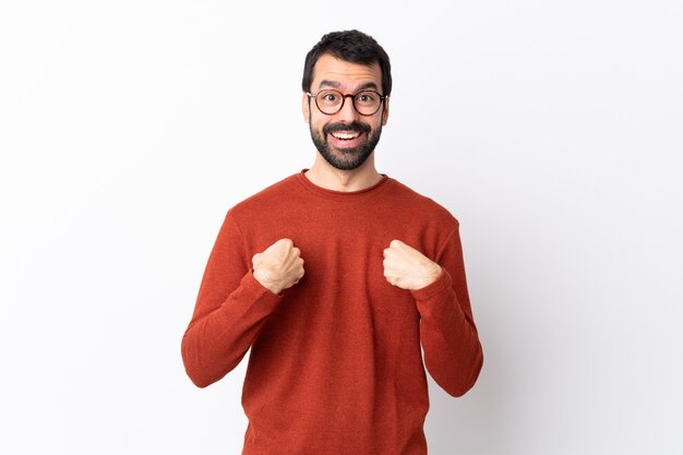 Caucasian handsome man with beard over white with surprise facial expression