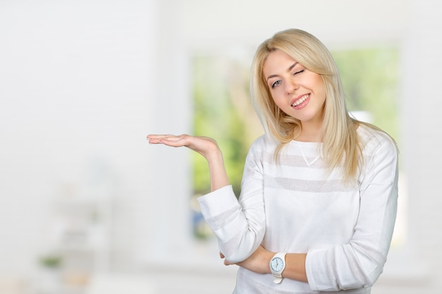 Caucasian isolated blond woman presenting with her hands