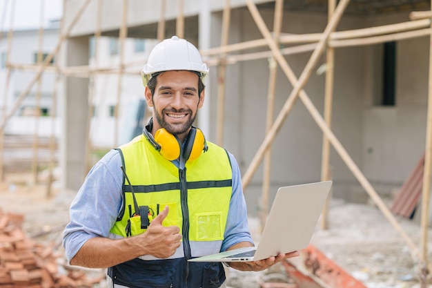 Caucasian latin worker foreman home builder hand sign thumbs up for good pass build and safety quality confirm concept