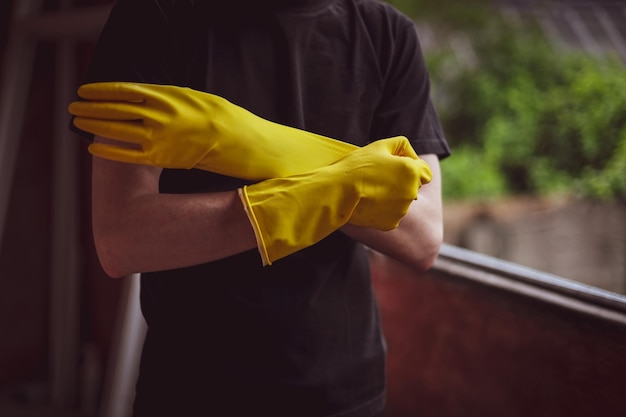 Caucasian male builder wears yellow gloves