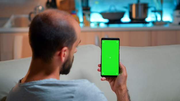 Caucasian male reading online social information on phone