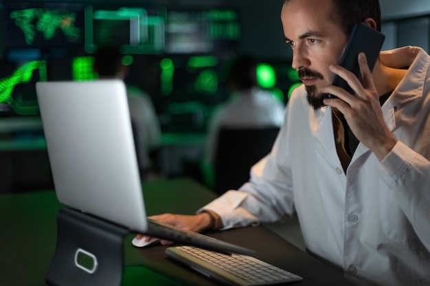 Caucasian male scientist doctor working in the lab using laptop and talking on the phone