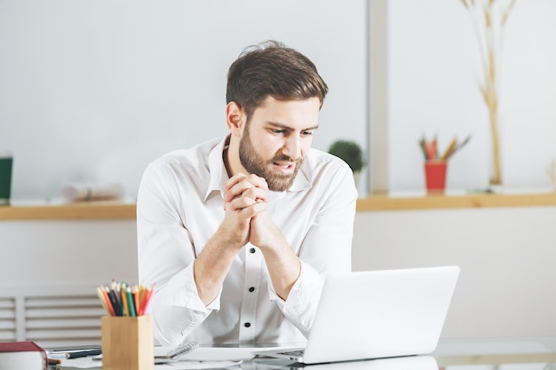 Caucasian male using laptop