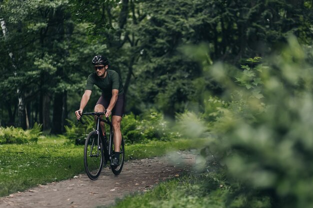 Caucasian man cycling during morning time at green park