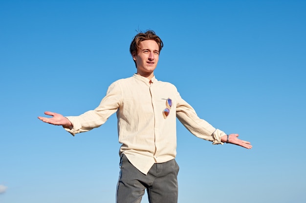 A Caucasian man from Spain acting confused and surprised on clear sky