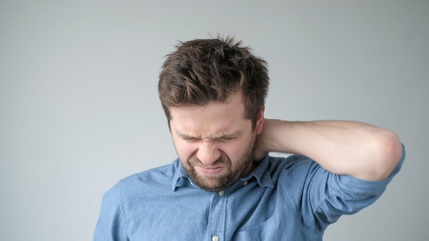 Caucasian man has neck and shoulder pain