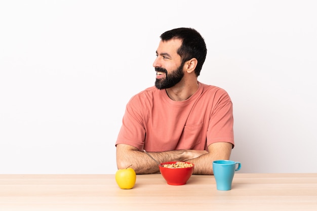 Caucasian man having breakfast in a table looking side