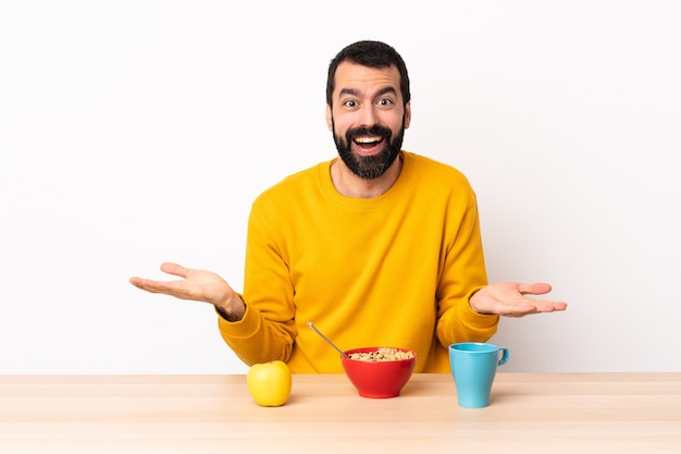 Caucasian man having breakfast in a table with shocked facial expression