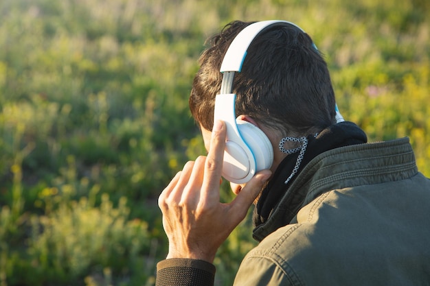 Caucasian man holding headphones at outdoor