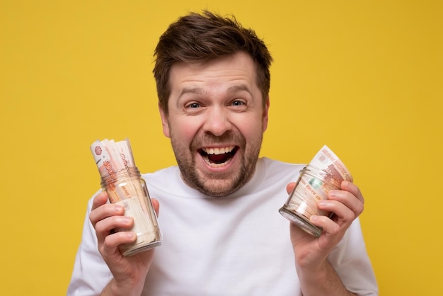 Caucasian man holding money Studio shot