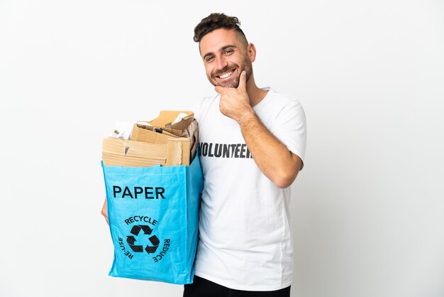 Caucasian man holding a recycling bag full of paper to recycle isolated on white background happy and smiling