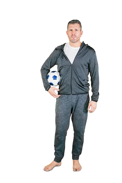 Caucasian man holding a soccer ball on studio