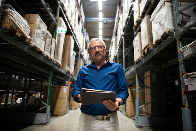 A Caucasian man is checking stock inventory