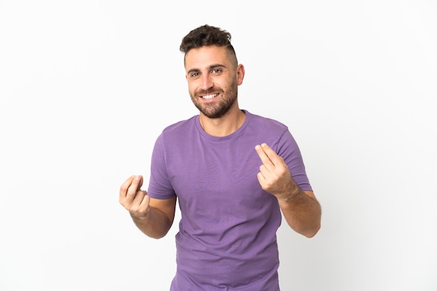 Caucasian man isolated on white background making money gesture