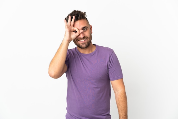 Caucasian man isolated on white background showing ok sign with fingers