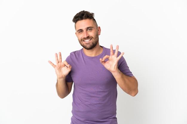 Caucasian man isolated on white background showing ok sign with two hands