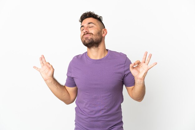 Caucasian man isolated on white background in zen pose