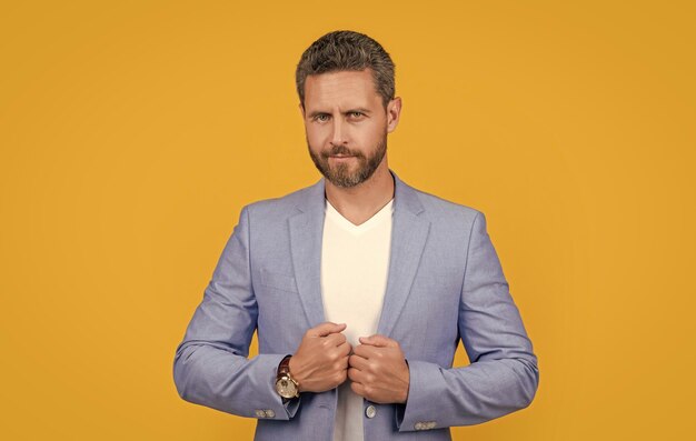 Caucasian man in jacket isolated on yellow background man in studio photo of handsome man