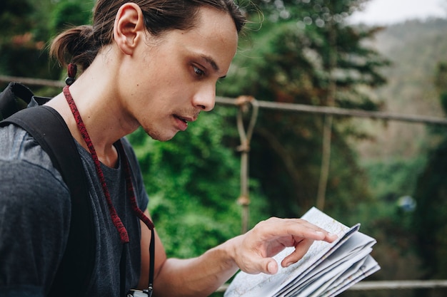 Caucasian man looking at a map travel and explore concept