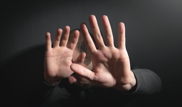 Caucasian man making stop gesture.