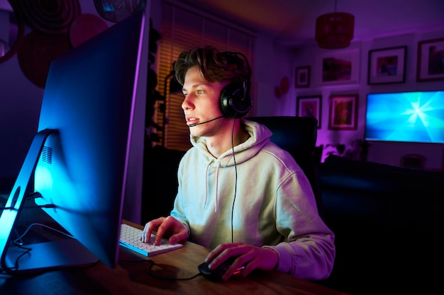 caucasian man playing game at night among neon lightning