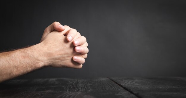 Caucasian man praying in the dark room