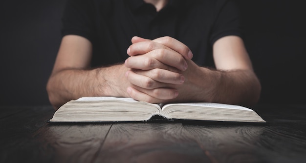 Caucasian man praying in the dark room