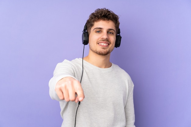 Caucasian man on purple listening music