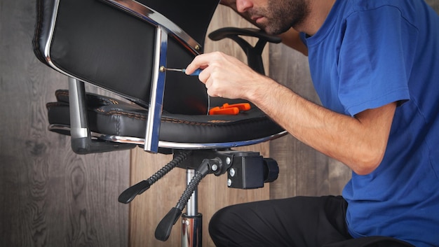 Caucasian man repairing office chair