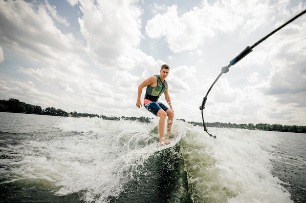 Caucasian man riding stylish wakeboard