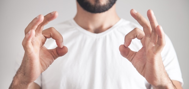 Caucasian man showing ok gesture.