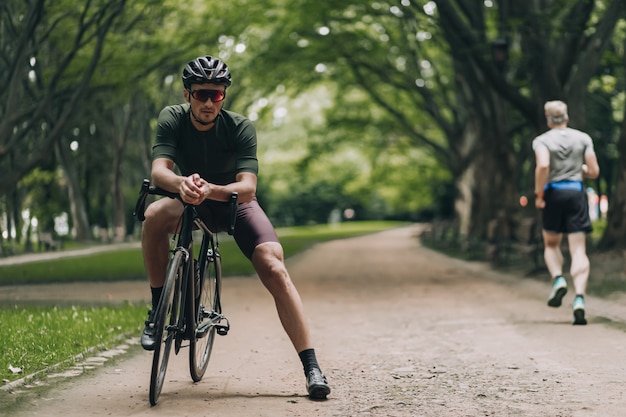 Caucasian man sitting on bike after workout at park