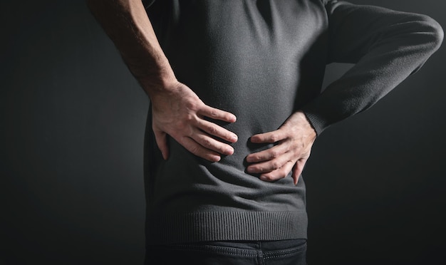 Photo caucasian man suffering from back pain.