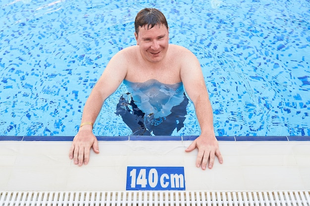 Caucasian man in swimming pool. Sports, aqua fitness. Summertime relax
