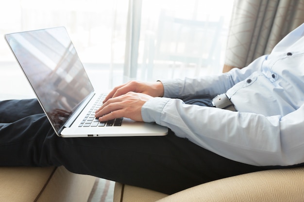 Caucasian man using laptop at table