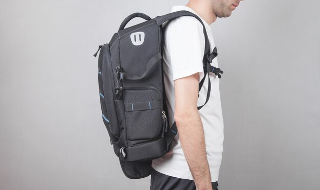 Caucasian man with backpack in office.