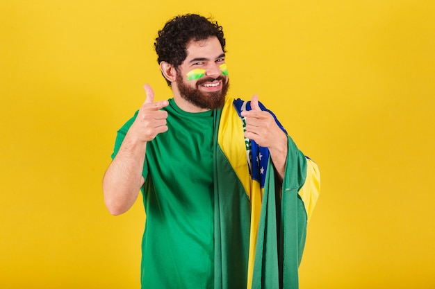 Caucasian man with beard brazilian soccer fan from brazil advising suggesting indicating pointing