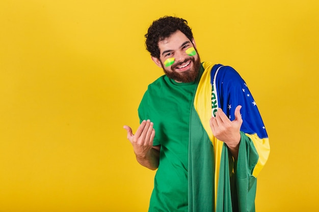 Caucasian man with beard brazilian soccer fan from brazil calling with hands come come welcome