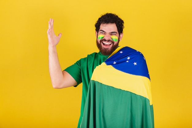 Caucasian man with beard brazilian soccer fan from brazil celebrating team goal screaming goal