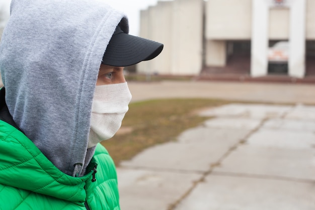 Caucasian man with medical protective face mask illustrates pandemic coronavirus